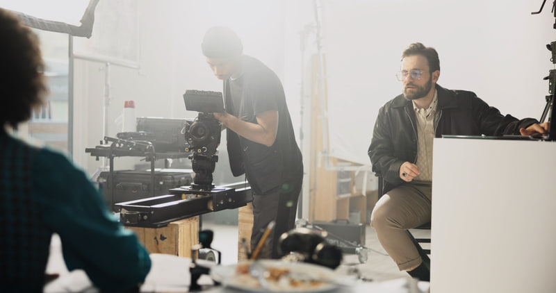 Camera crew preparing a shot on a warmly lit film set.